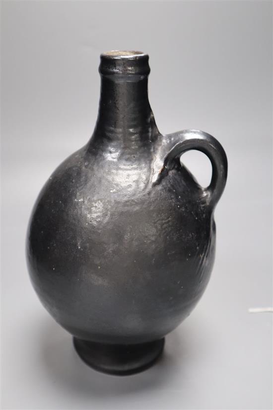 A Martin Brothers black glazed flagon, signed and dated 1909, height 23cm
